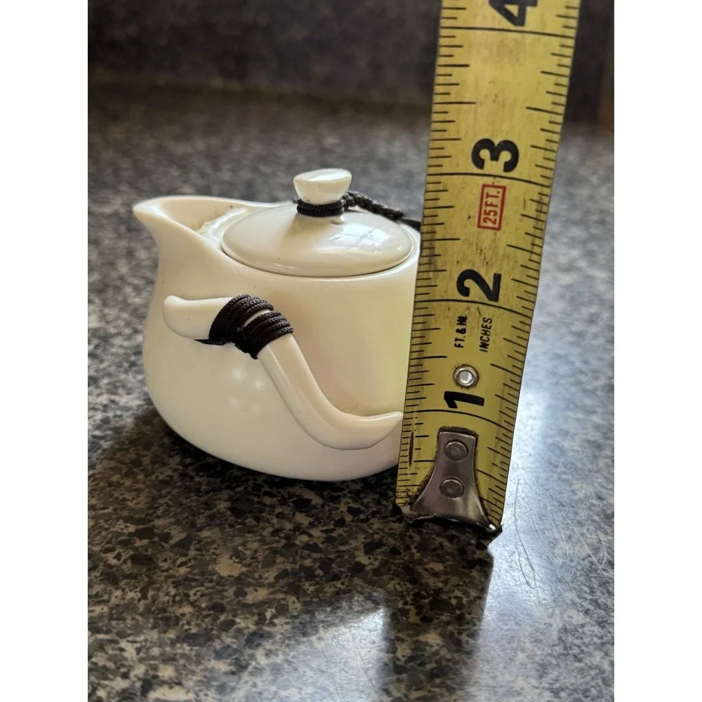 Compact travel tea pot white ceramic with decorative cord
